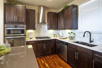 Modern kitchen with stainless steel appliances at the Townhomes at Woodmill Creek
